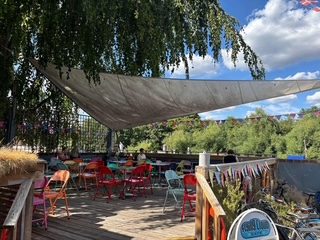 The terrace with colourful chairs and sail shade