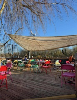 Colourful terrace chairs by the river